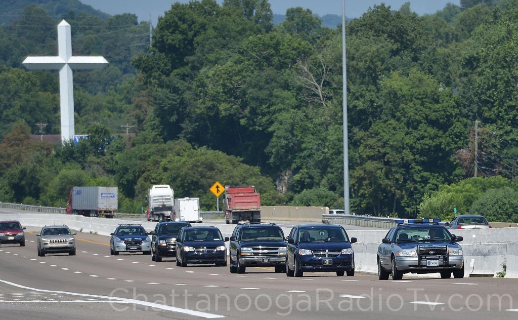  Virginia State Police cars escort 4 funeral home vans on I81 North on Friday, July 17, 2015 in Bristol, Virginia under the large cross at Victory Baptist Church. The multicar escort is traveling from Chattanooga, Tennessee through Bristol, Virginia on the way to Dover, Deleware with the bodies of Marines killed in Thursday's Shooting in Chattanooga, Tennessee. Photo Earl Neikirk/Bristol Herald Courier/HeraldCourier.com
